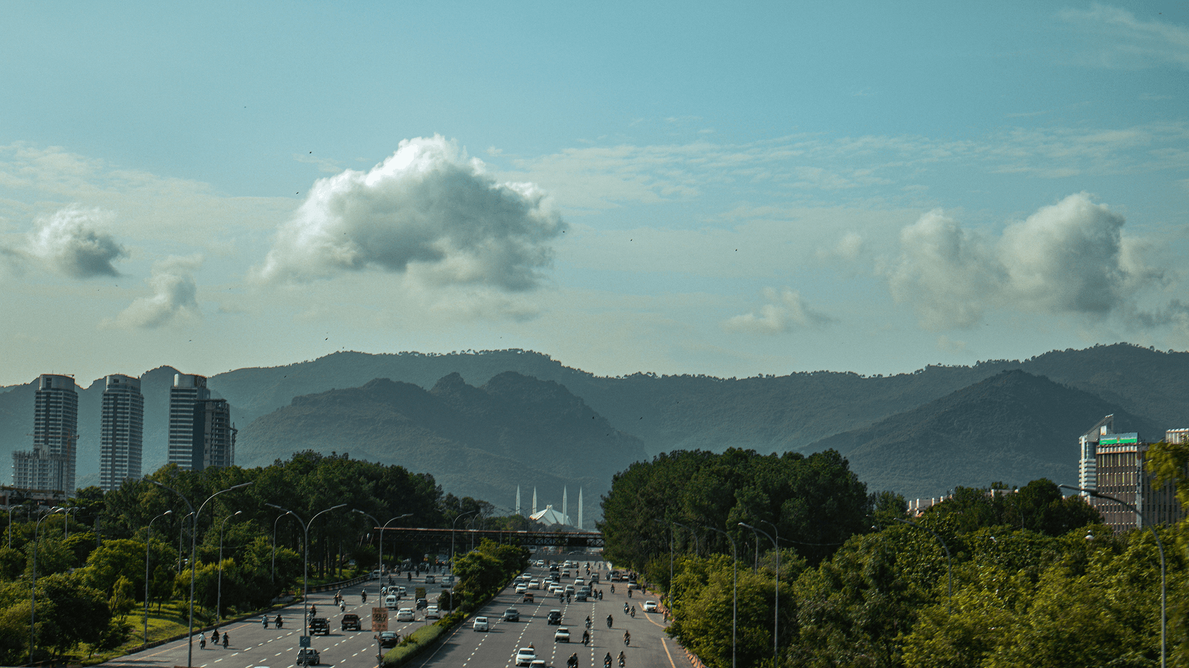 View of Islamabad's skyline showing Centaurus, the Faisal Mosque minarets, and the green Margalla Hills beyond